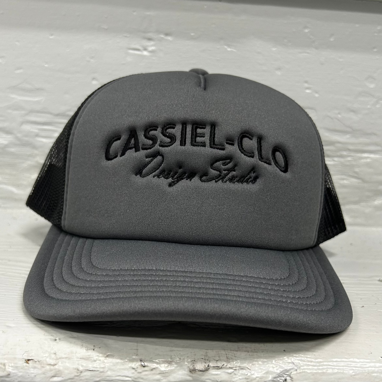 Cassiel Arch Logo Grey Foam Trucker Cap
